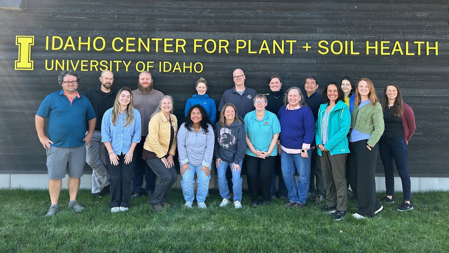 A group of NPDN members standing in two rows under a Sign reading Idaho Center for Plant and Soil Health